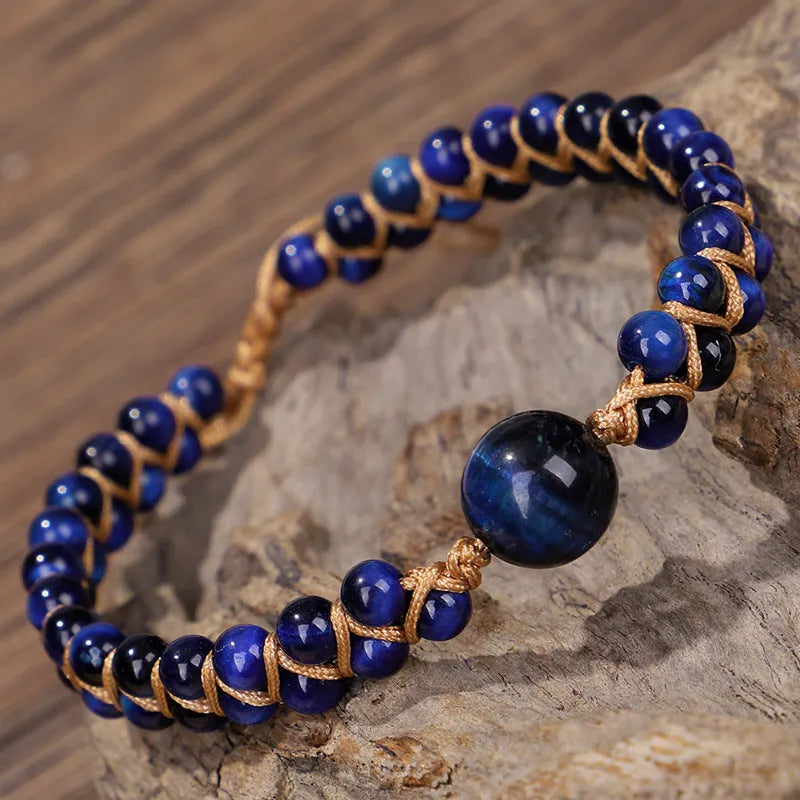 Handmade woven bracelet with geometric pattern in blue tigereye stone beads and pull closure.
