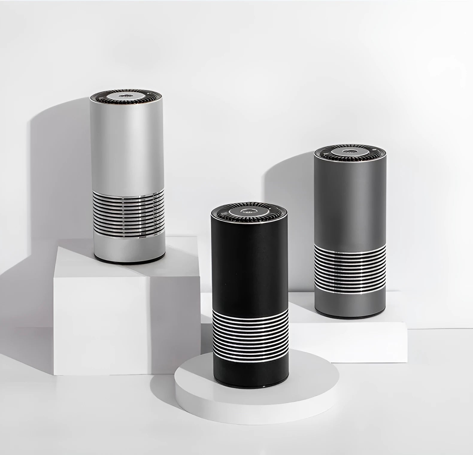 Compact cylindrical car air purifier in metallic grey with aluminium alloy casing.