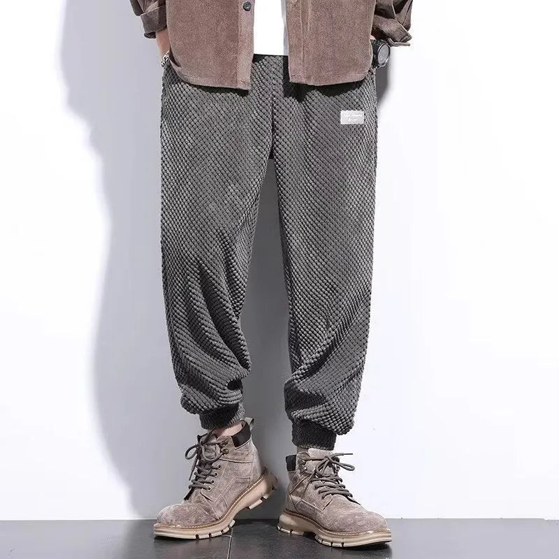 Men's grey ankle-tied casual sweatpants with a light straight leg on a neutral background.