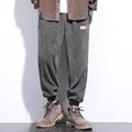 Men's grey ankle-tied casual sweatpants with a light straight leg on a neutral background.