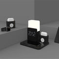 A dark green 3-in-1 Qi wireless charging stand on a desk, showing its foldable design and charging pad.