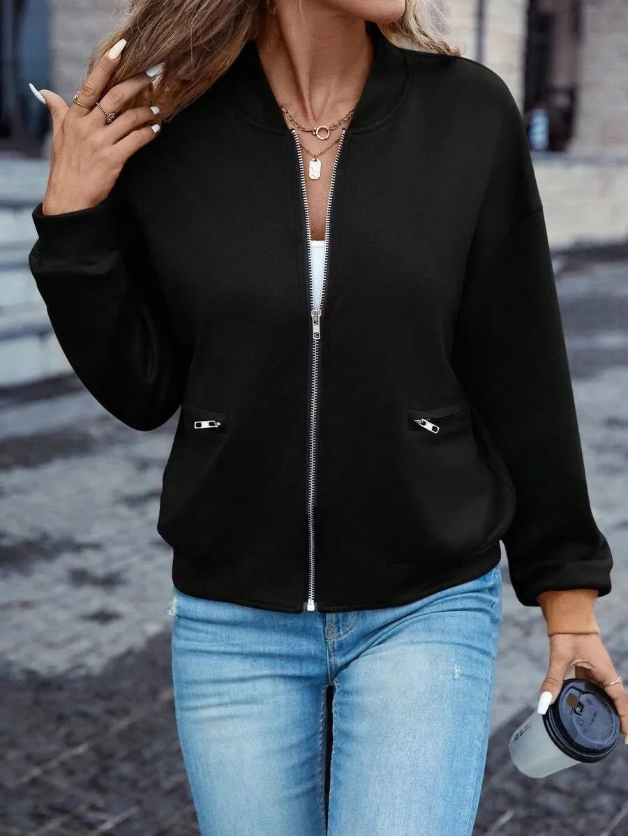Black women's zip jacket with faux pockets and long sleeves on hanger