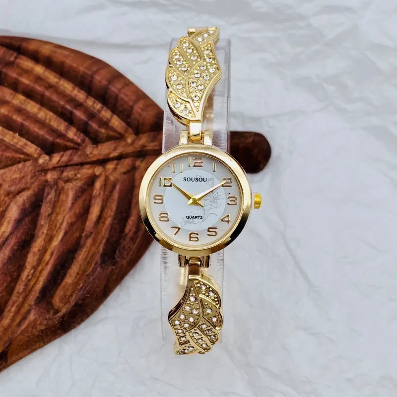 Women's stainless steel fashion watch with round gold dial and vachette clasp.