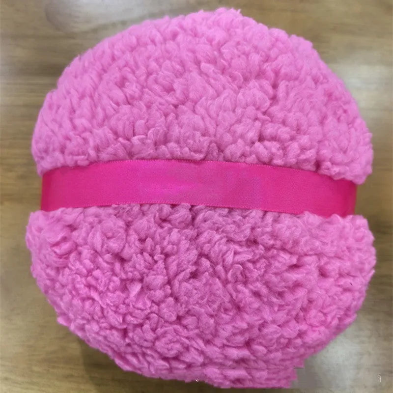 Oversized plush dry powder puff measuring 150x75mm for loose powder application in white skin colour