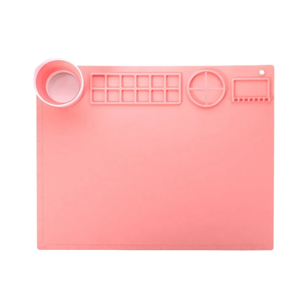 Light blue silicone painting mat with two round bowls on a 50cm by 40cm rectangular surface.