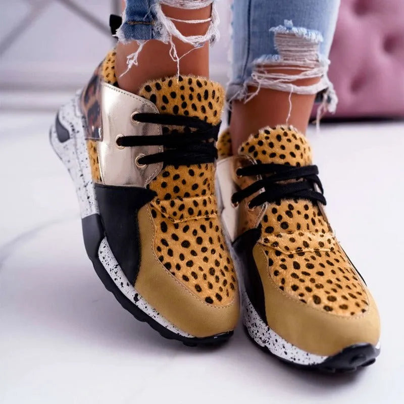 Women's casual suede sneakers with a wedge heel in various colours including black, pink, and leopard print.