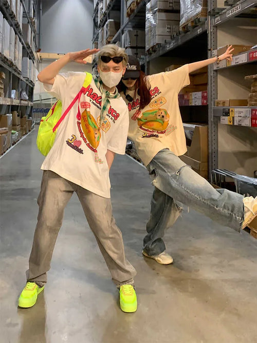White short-sleeved cotton t-shirt with a cartoon hamburger dog graphic print, shown on a model.
