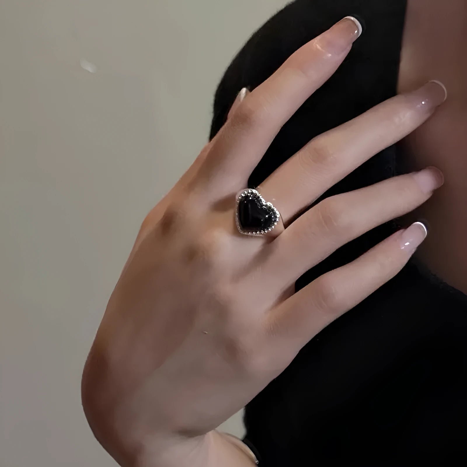 Adjustable open mouth sterling silver ring with a black agate heart on a silver band.