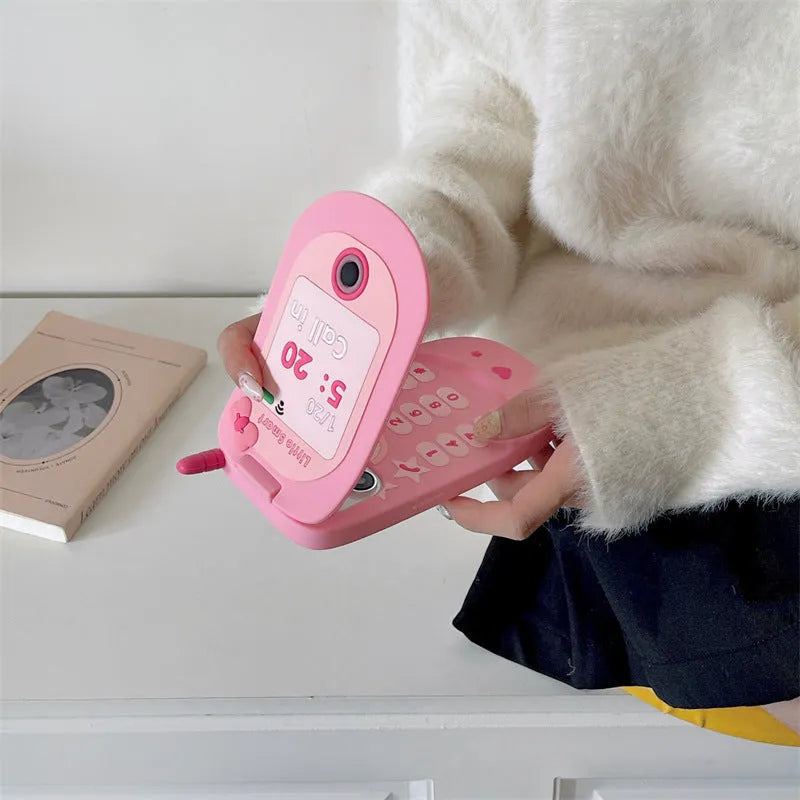 Pink silicone flip phone shape case with a mirror, designed for iPhone models.