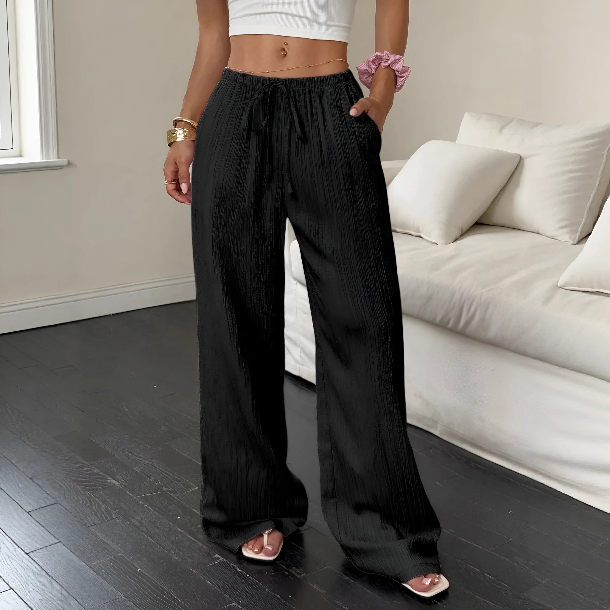 Women's black wide-leg trousers with lace-up waist trimming detail on hanger