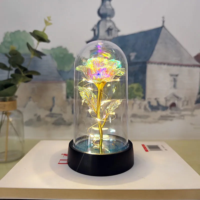 Small plastic night lamp with floral decoration and coloured light options on a black base.