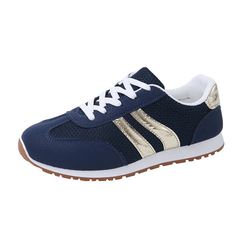 Blue women's lace-up tennis shoes with cross shoulder straps and a flat rubber sole.