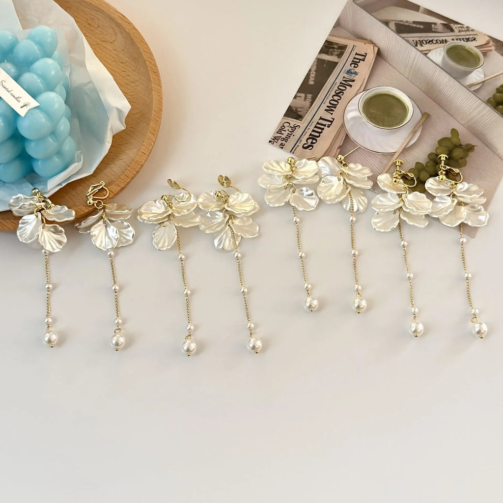 Women's acrylic shell pearl tassel earrings showing four different clip style options