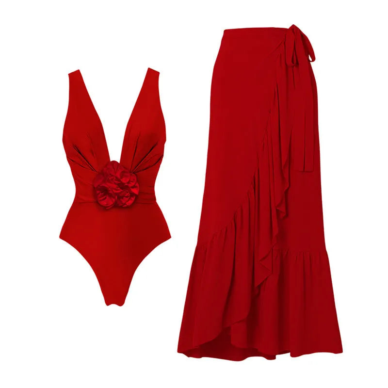 Red women's V-neck one-piece swimsuit with detachable flower and matching skirt on beach