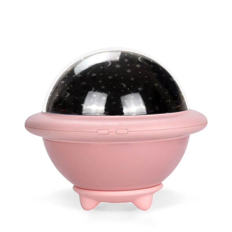 Green UFO-shaped starry sky projection night light on a table, showing rotating planet display on wall.