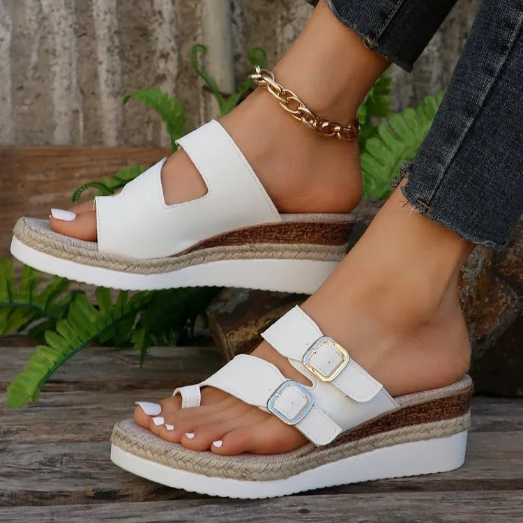 White patent leather women's sandals with wedge heel and woven finger-fit straps in peep toe design