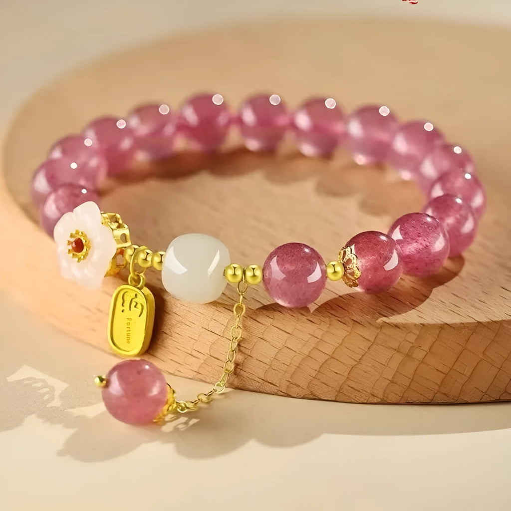 Adjustable strawberry quartz bracelet with Hetian jade peach blossom charm on wrist