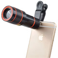 12X magnification phone telescope lens with mounting clip on a black smartphone