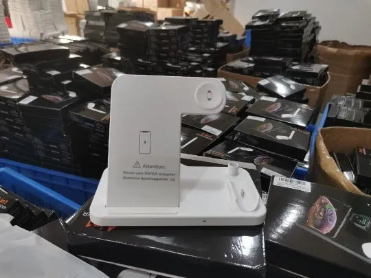 Folding 4-in-1 wireless charger in space grey colour, shown upright as a phone stand with an iPhone charging.