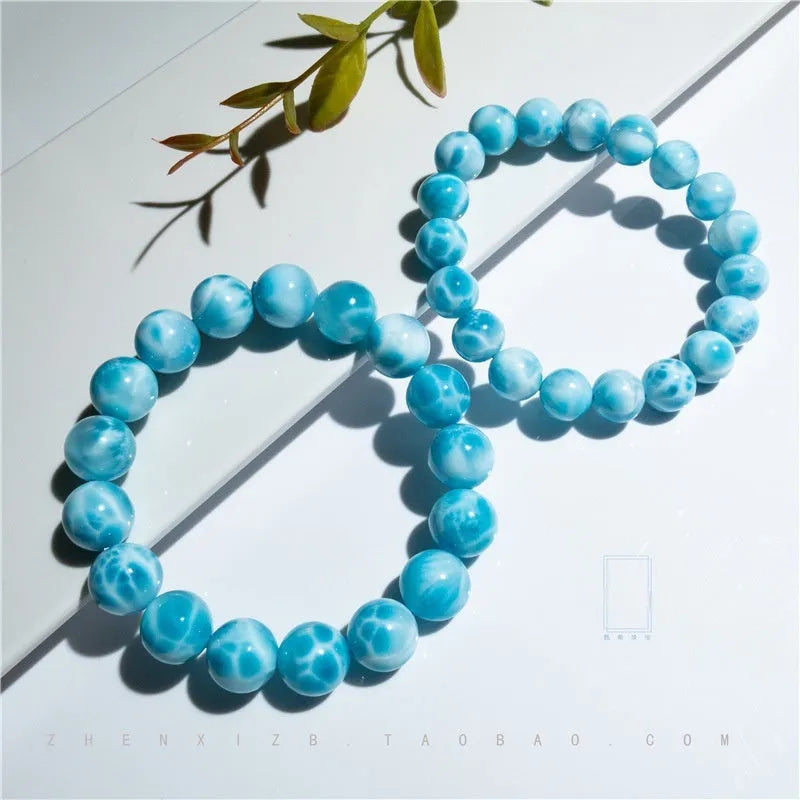 Blue Maillard style Bodhi bracelet with a natural sea-pattern crystal stone and pearl beads on wrist.
