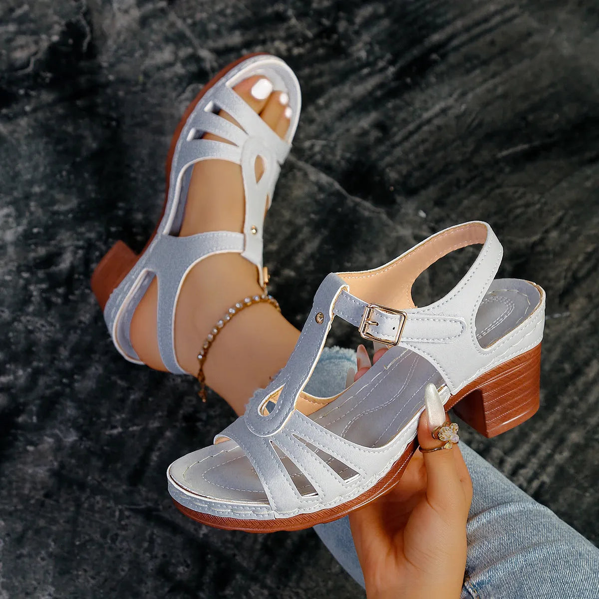 Women's black PU peep toe wedge sandals with a buckle strap on a light background