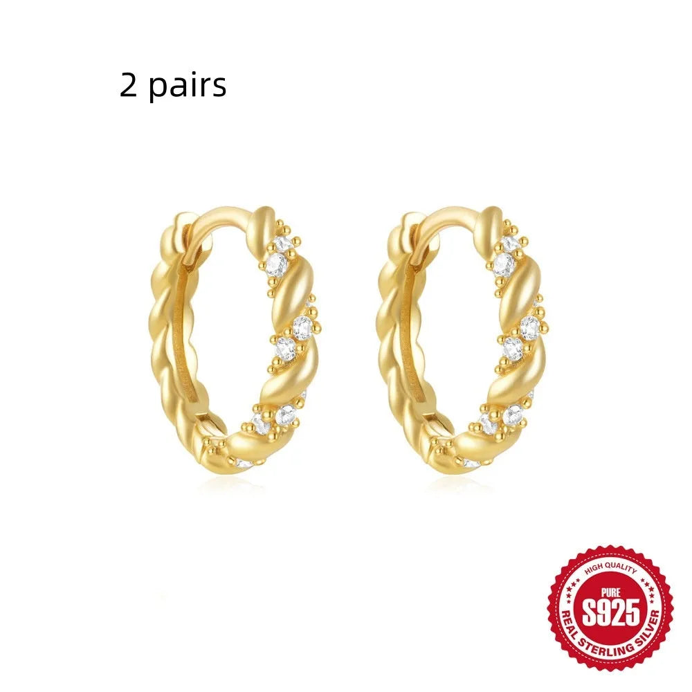 Sterling silver geometric stud earrings with small round diamond detailing in gold and silver electroplated finishes