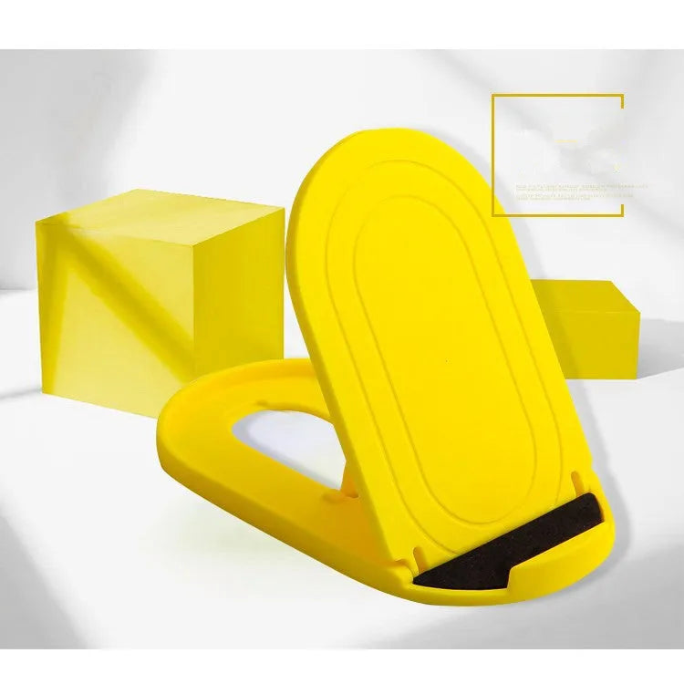 A lazy bracket style mobile phone stand made of plastic, shown in multiple colour options on a wooden desk.