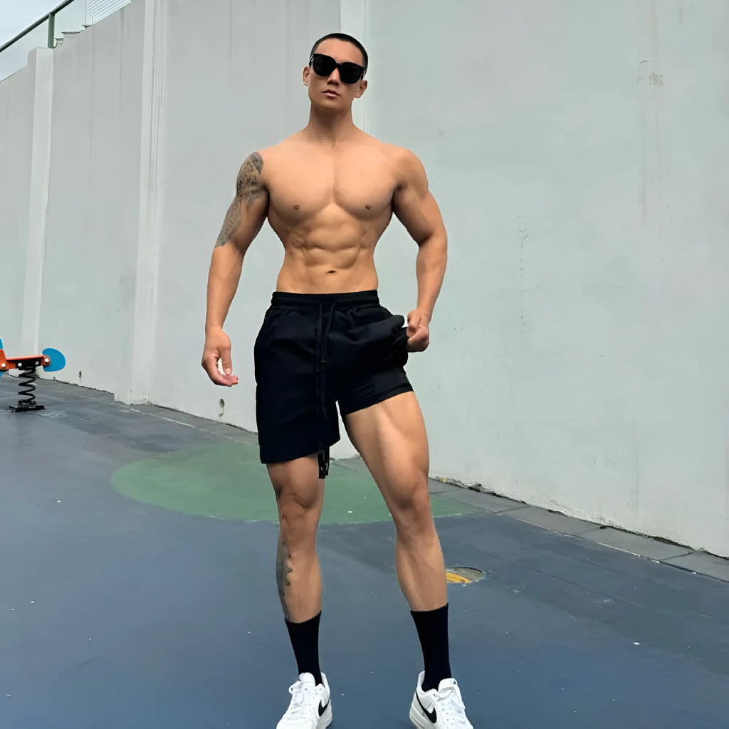 Men's ice silk quick-drying double-layer shorts in light grey, showing casual fit and elastic waistband.