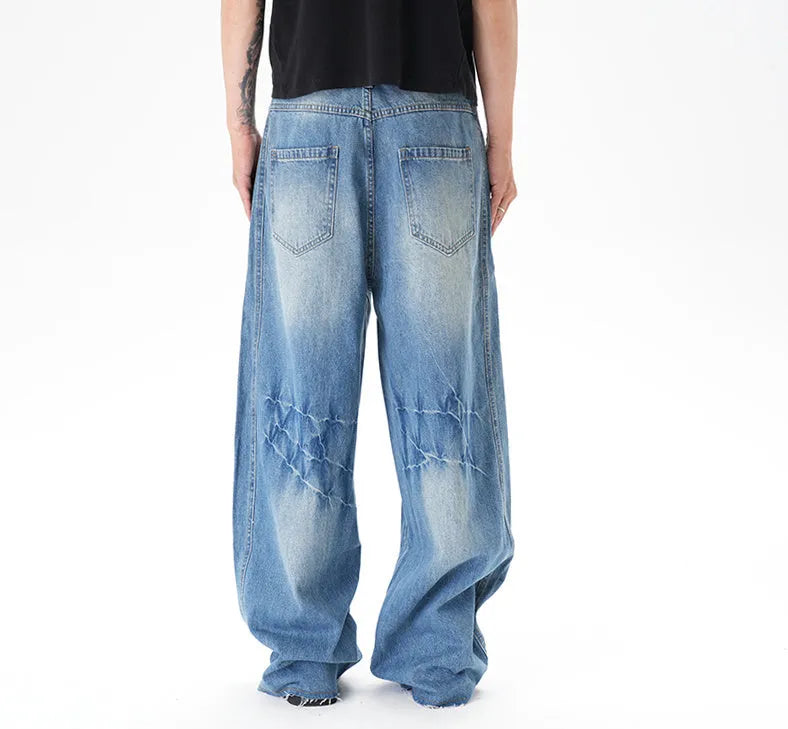 Light blue vintage washed wide leg machete jeans with a straight fit and zipper fly on a model.