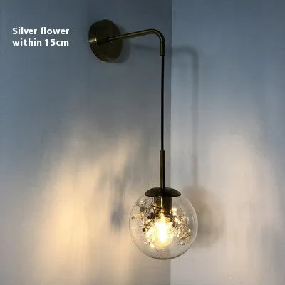 Modern glass wall lamp in golden flower or silver flower finish, shown in 15cm and 20cm sizes