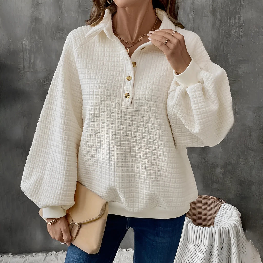 Women's milky white sweater with a polo collar and long sleeves laid flat.