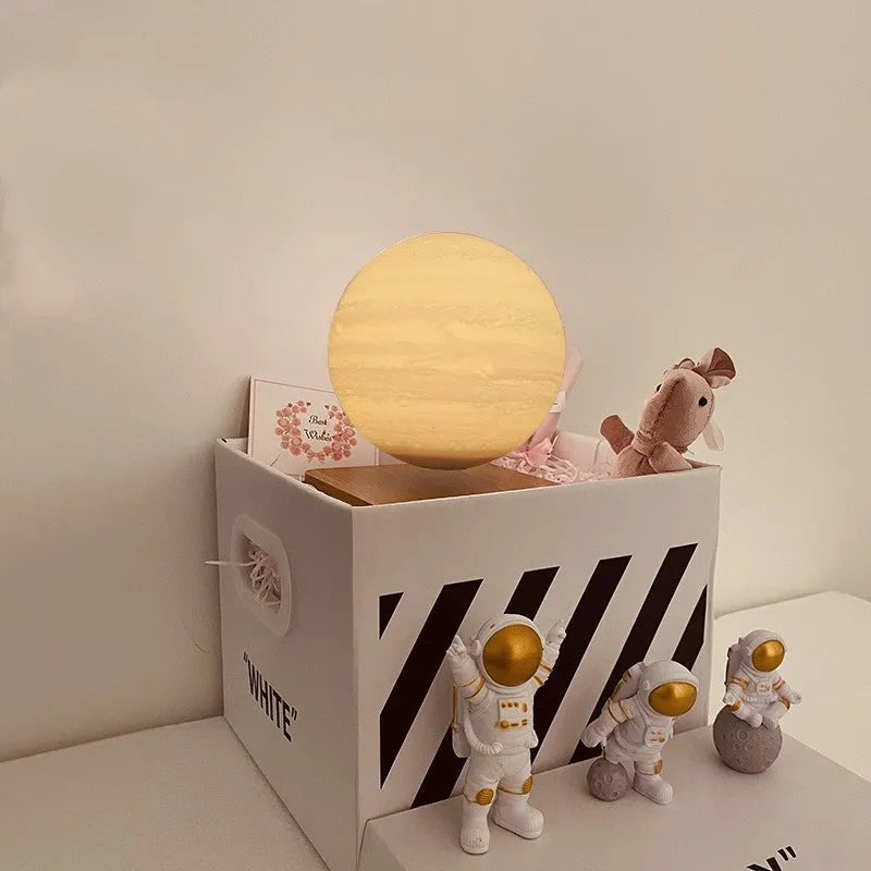 Floating magnetic levitation moon planet lamp with LED light and astronaut figures on desk