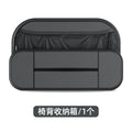 Black leather car seat rear storage bag hanging behind a vehicle seat.
