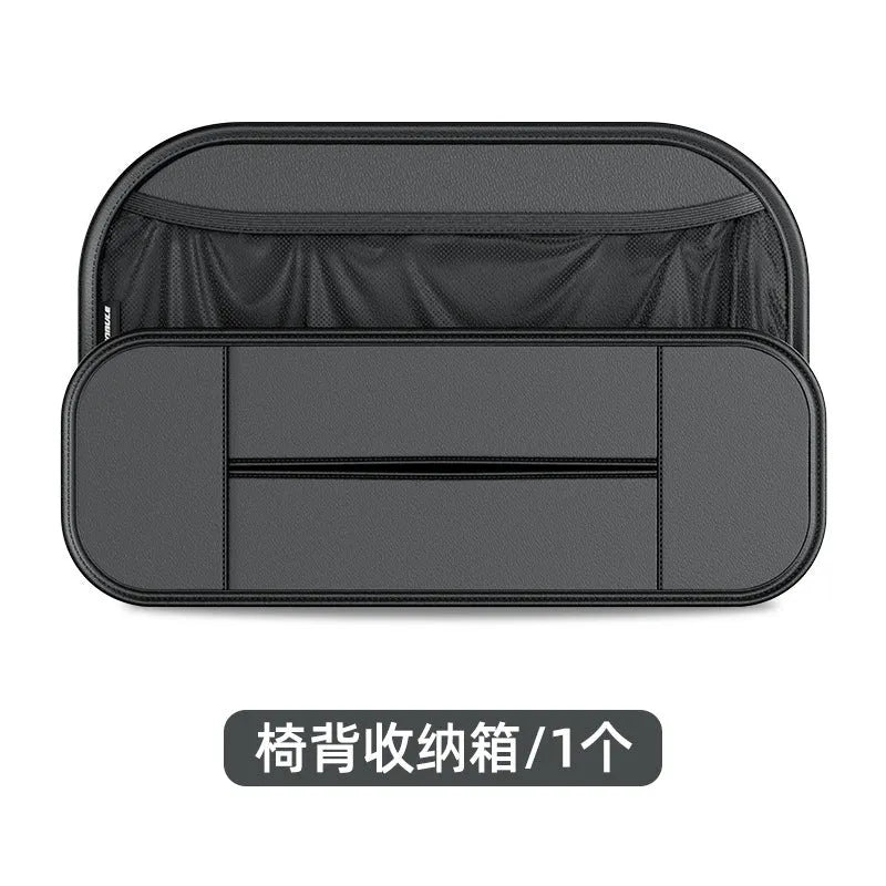 Black leather car seat rear storage bag hanging behind a vehicle seat.