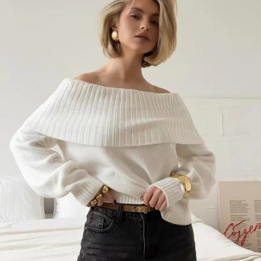 Grey off-the-shoulder sweater with a 3D pattern and strapless design, laid flat.