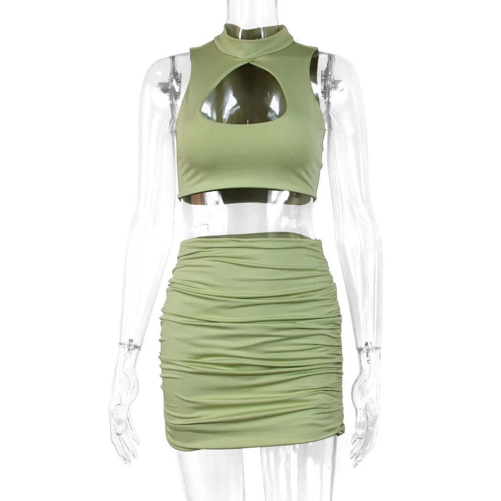 Light purple women's two-piece set with hollow vest and split skirt on a model.