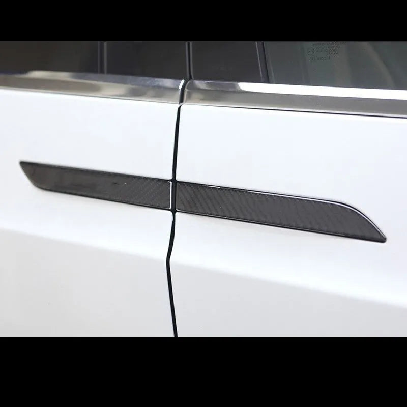 Four carbon fibre adhesive door handle protection stickers for Tesla Model S interior.