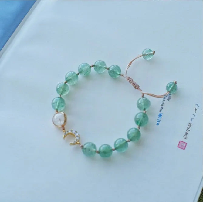 Adjustable strawberry quartz bracelet with Hetian jade peach blossom charm on wrist