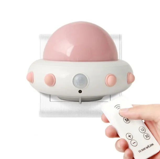 Remote control UFO shaped bedside night light in blue, pink, or white colour.