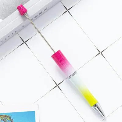 Creative ballpoint pen with multicoloured spinning plastic beads on a steel wire frame.