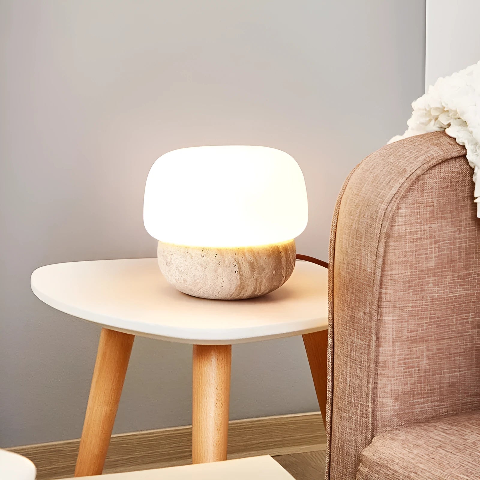 Cream-coloured retro style bedside table lamp with a warm white glow.