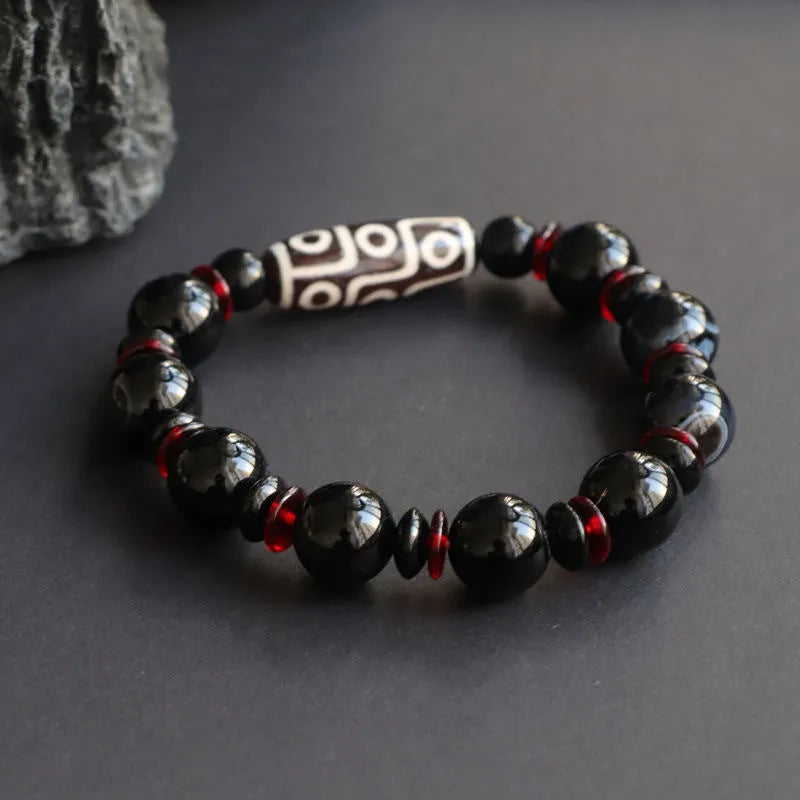 Hand-woven black agate dzi bead bracelet with geometry pattern on wrist