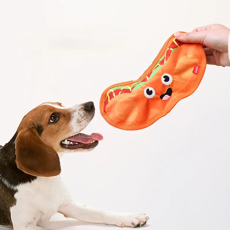 Set of four food-shaped dog toys: hamburger, fries, hot dog, and pizza, with vivid colours.