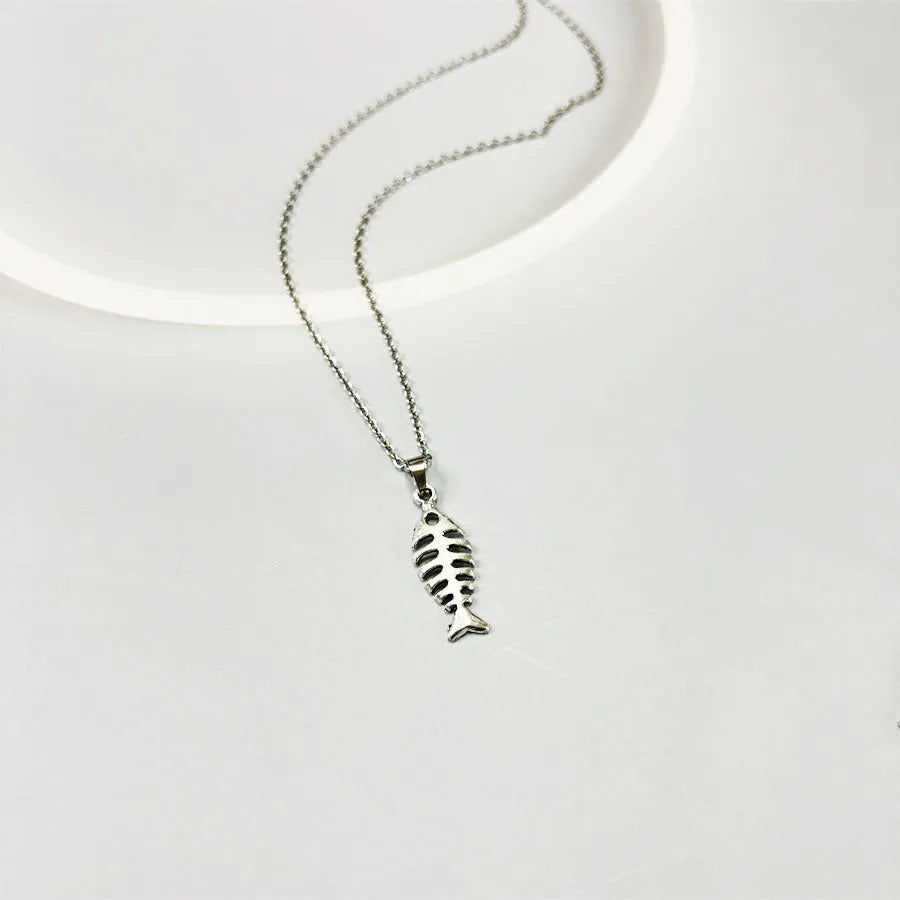 Women's fishbone pendant alloy necklace and matching earrings set on a white background