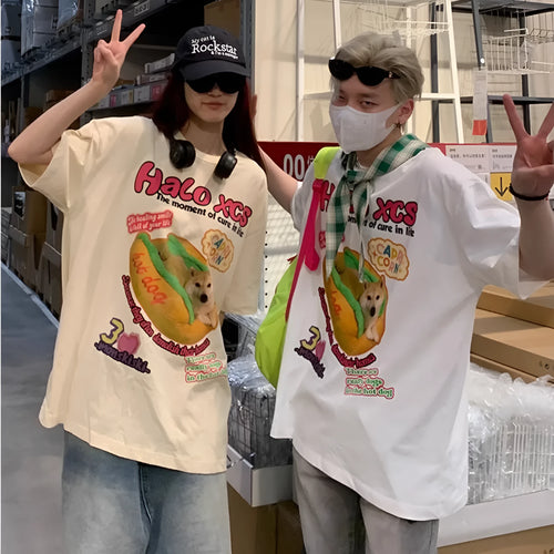 White short-sleeved cotton t-shirt with a cartoon hamburger dog graphic print, shown on a model.
