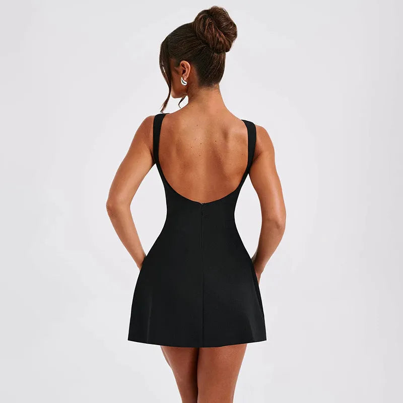 A woman wearing a slim-fitting black backless sleeveless summer dress with a high waist and short skirt.