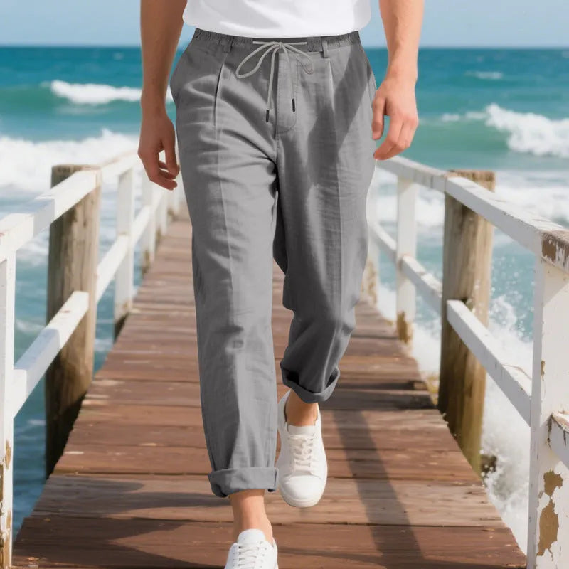 Men's light khaki linen casual trousers with a loose straight-leg fit and drawstring waist.