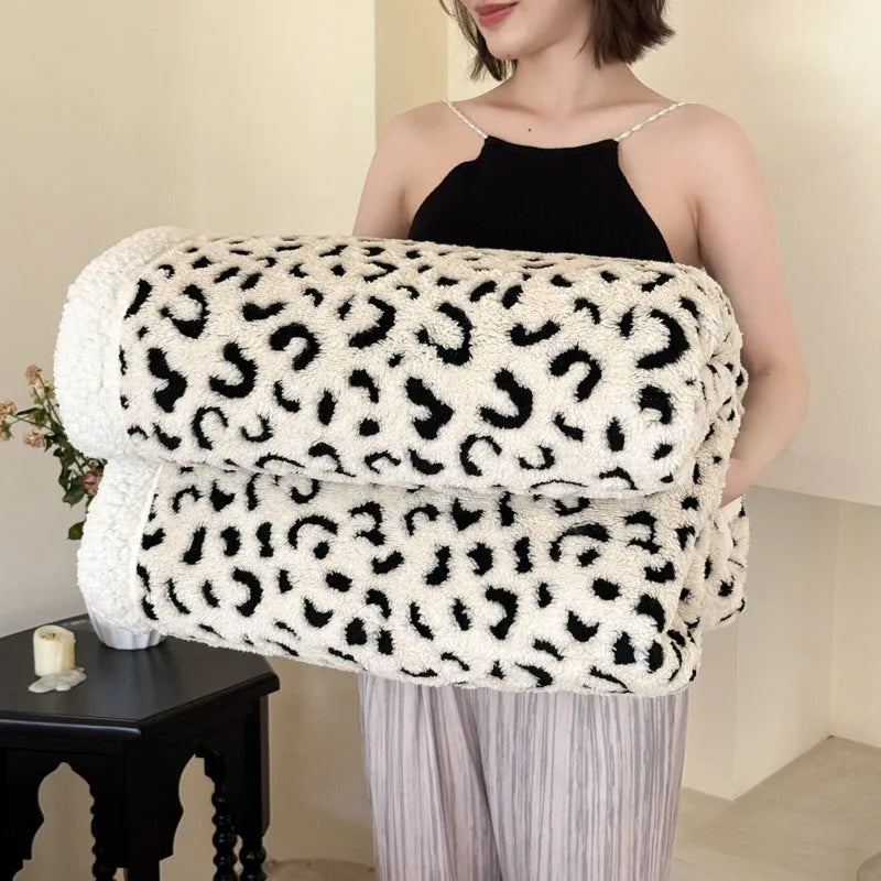 Double-layer Jacquard taffeta blanket with leopard print design in camel colour folded to show texture and pattern detail