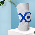Men's silicone knee pad for sports protection in a two-tone colour, shown on a knee.