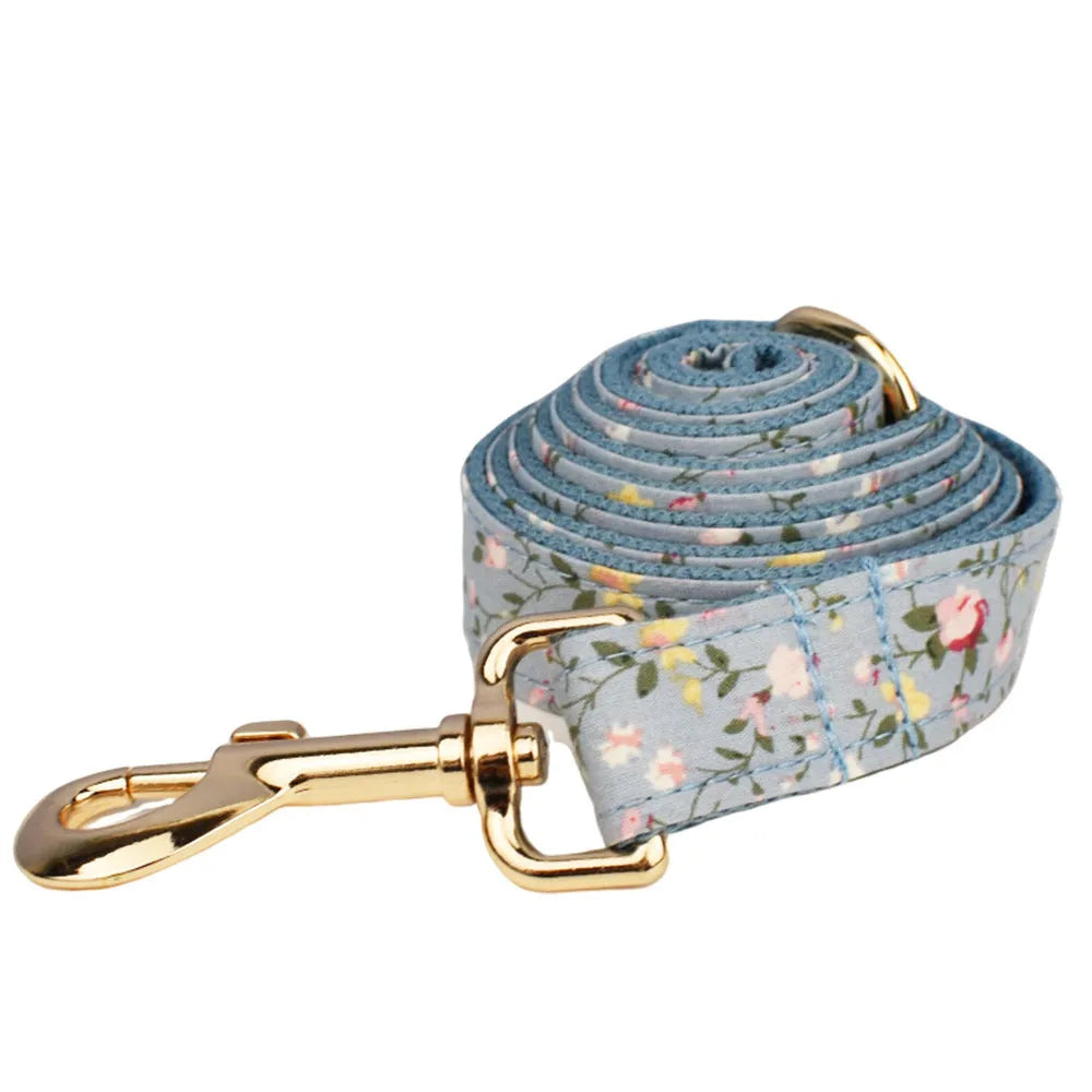 Blue floral polyester cotton dog collar and matching leash set with bow, vest, and poop bag accessories